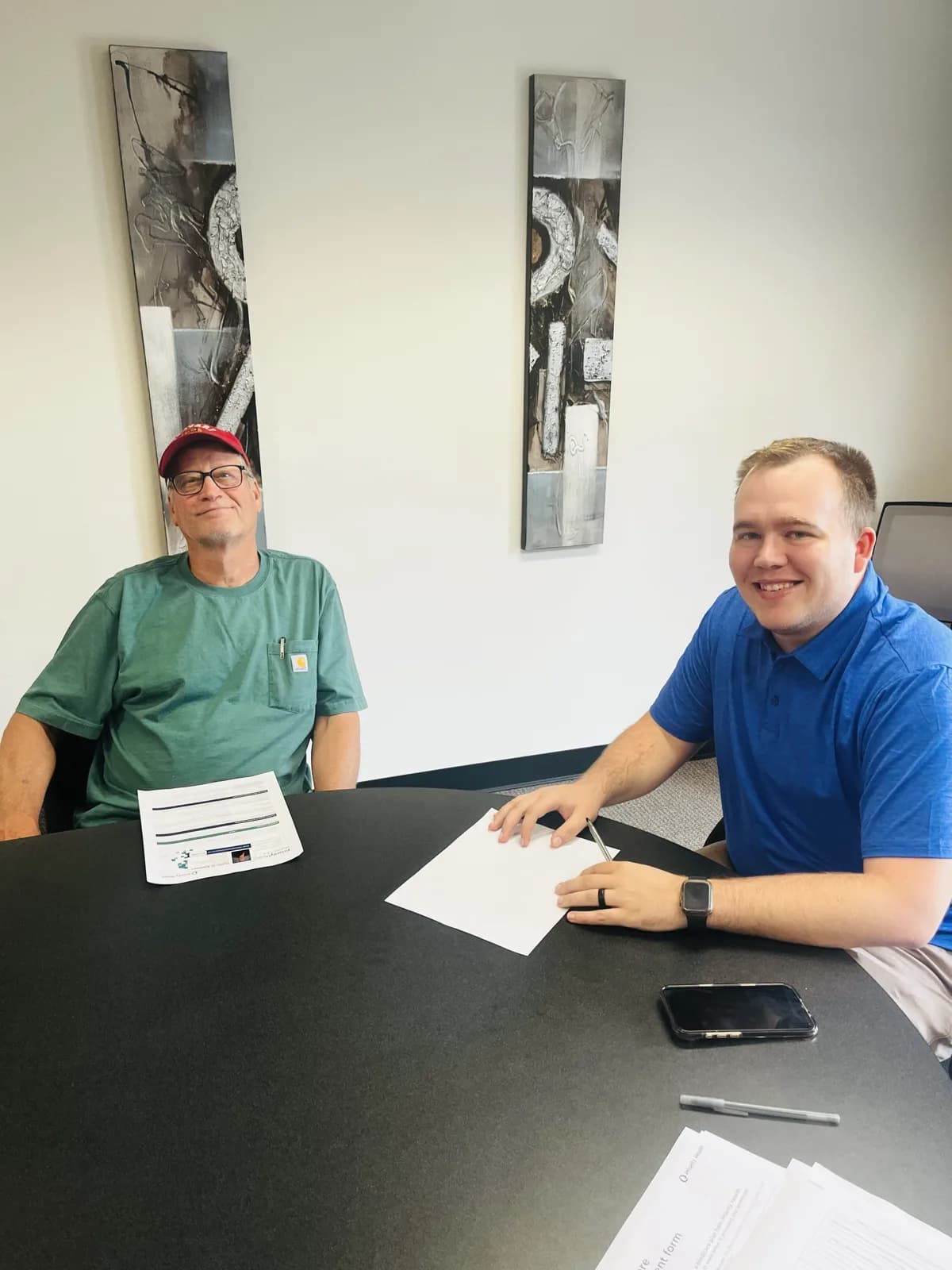 Hunter Klaassen going over Medicare options with a client at his Jackson, MI office